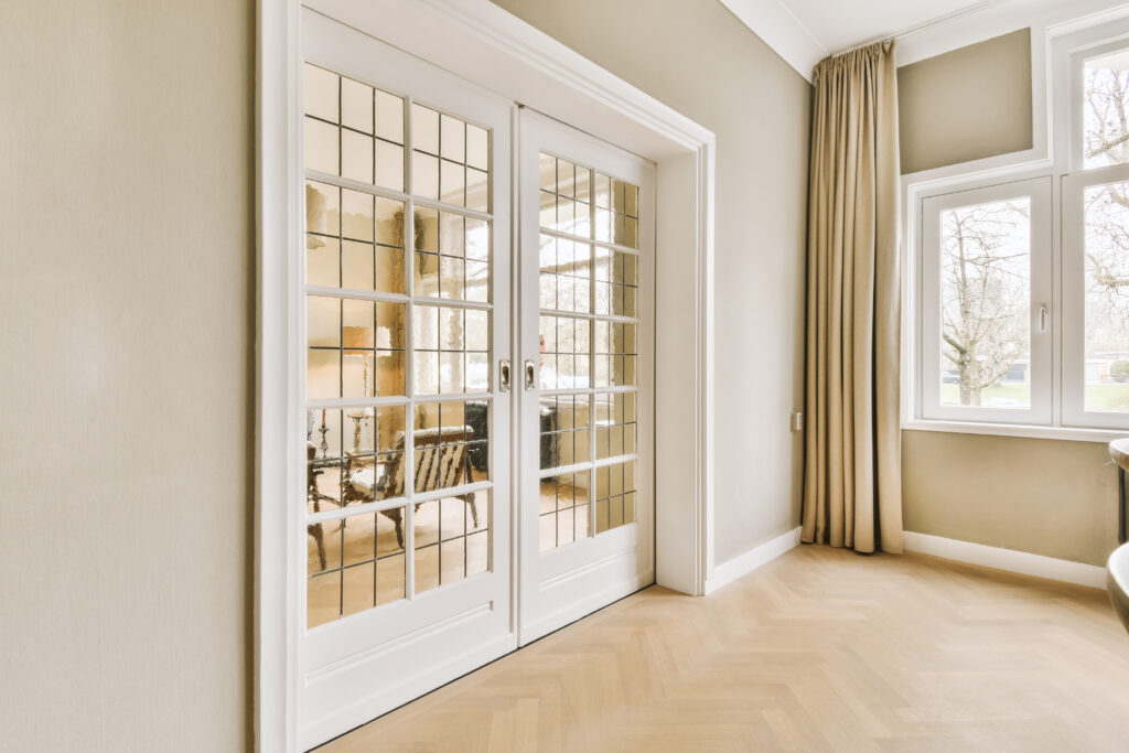 a living room with doors leading to a dining room